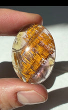 Load image into Gallery viewer, Cacoxenite in Quartz Cabochon with Amethyst