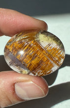 Load image into Gallery viewer, Cacoxenite in Quartz Cabochon with Amethyst