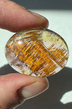 Load image into Gallery viewer, Cacoxenite in Quartz Cabochon with Amethyst
