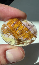 Load and play video in Gallery viewer, Cacoxenite in Quartz Cabochon with Amethyst
